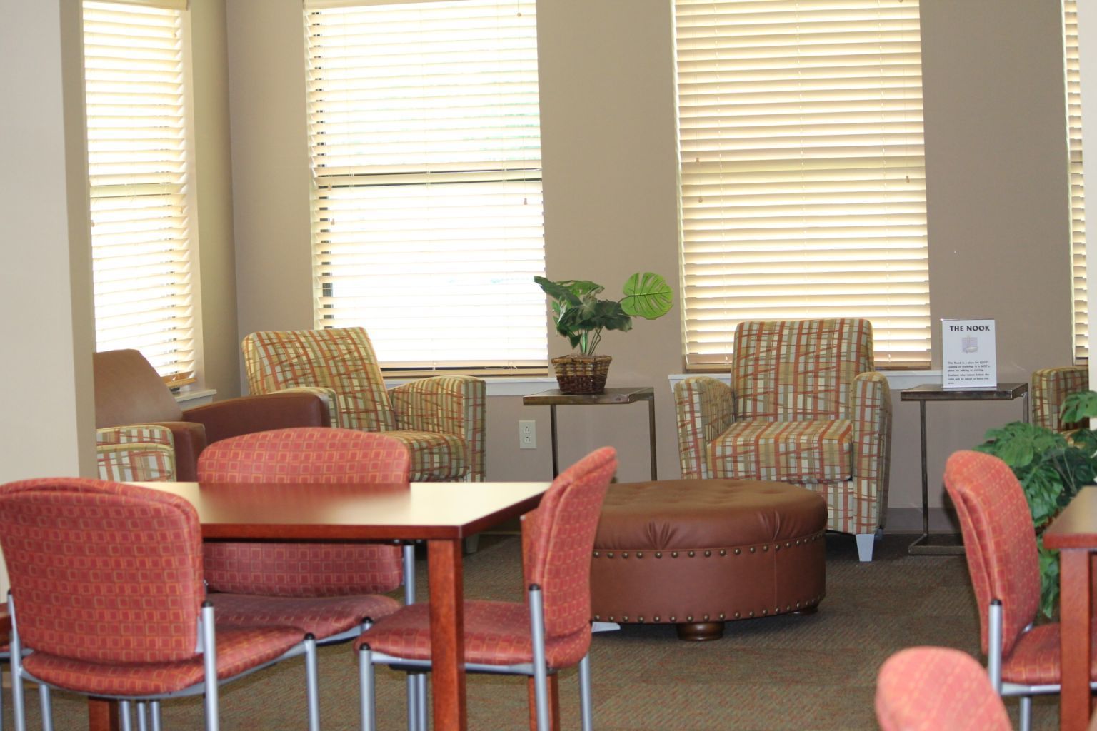 A room with tables and chairs and a sign that says ' a ' on it