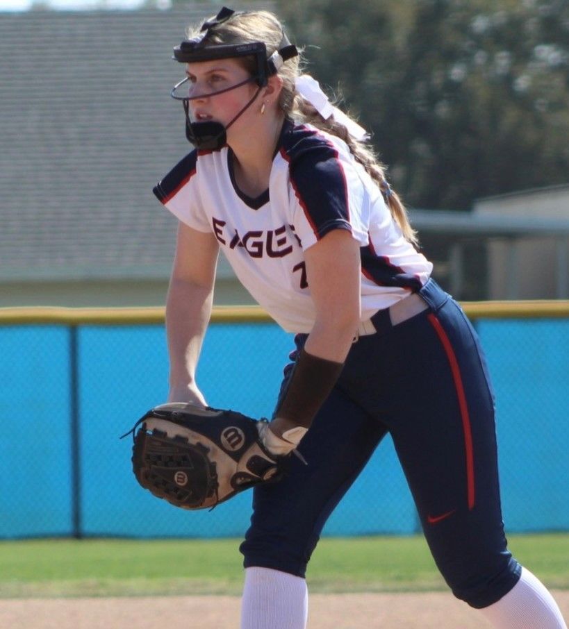 A female softball player with the number 1 on her jersey