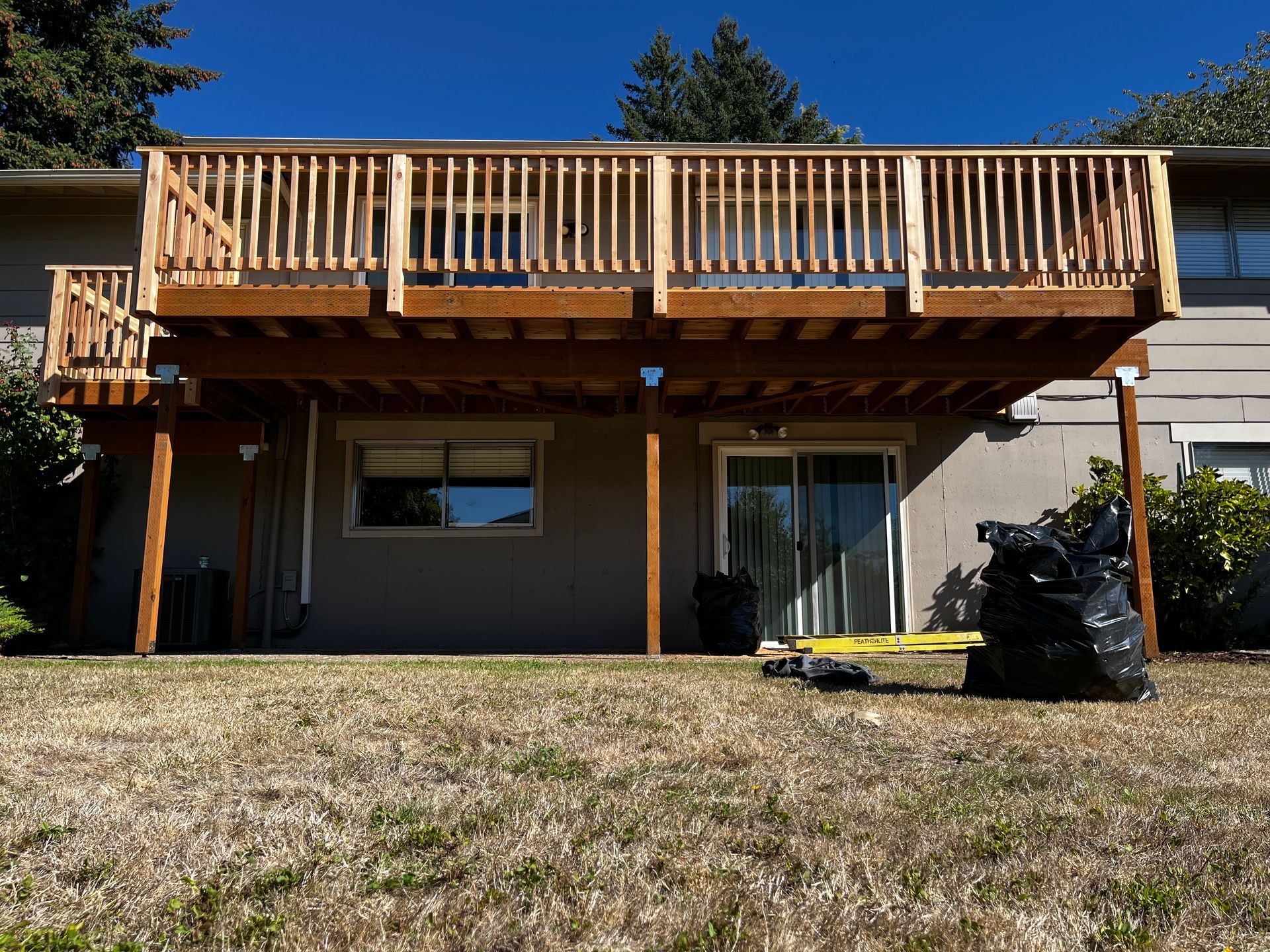 The back of a house with a large wooden deck.