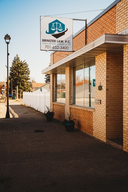 A brick building with a sign on the side of it.