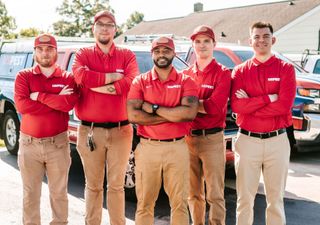 a group of people are sitting at desks in an office
