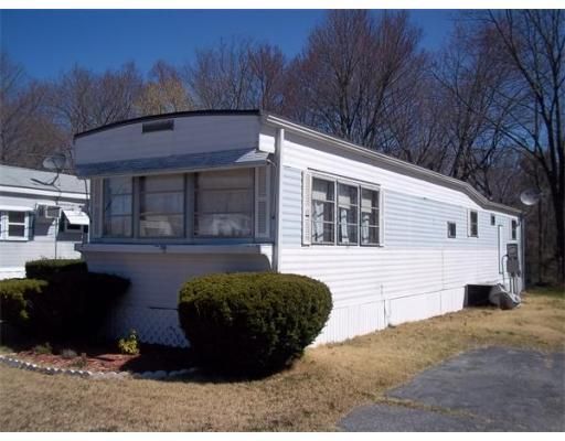 A white mobile home with a lot of windows