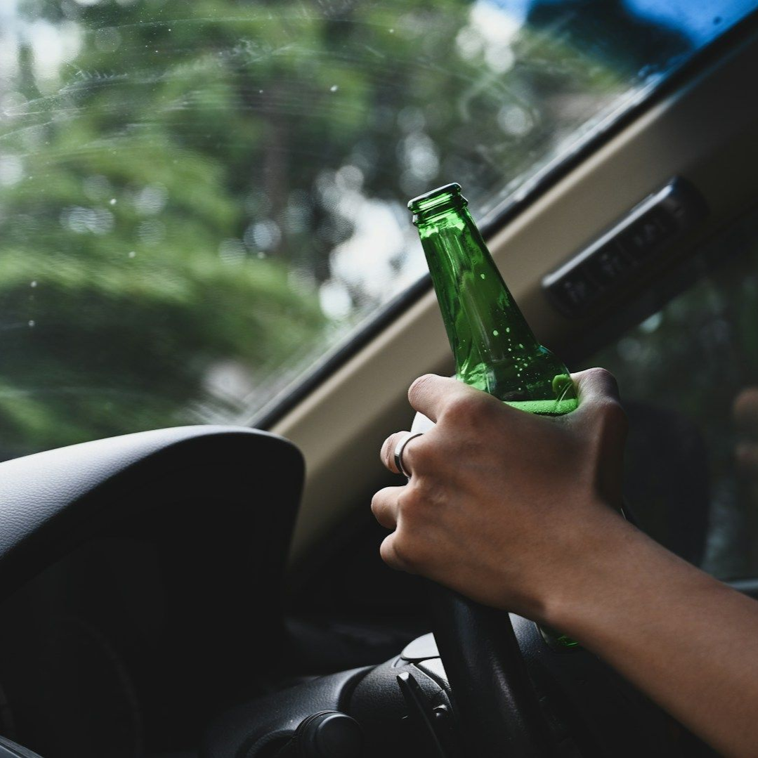 An elderly woman is sitting on a bench talking to a younger woman.