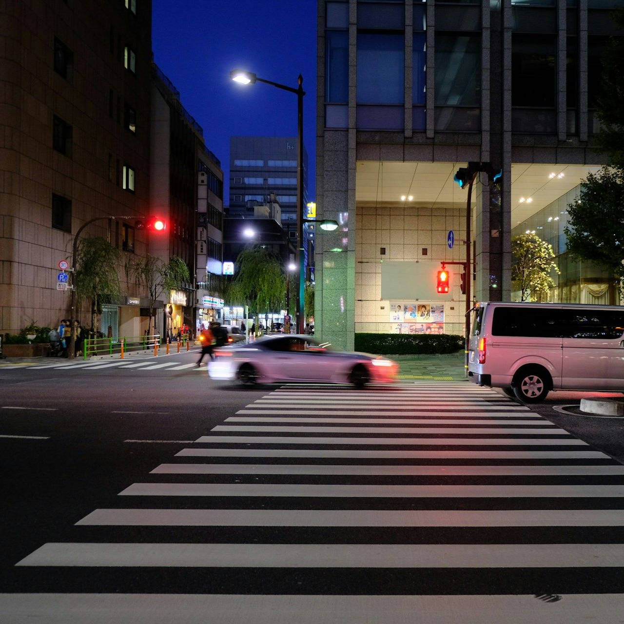 A group of people are hugging a little girl.