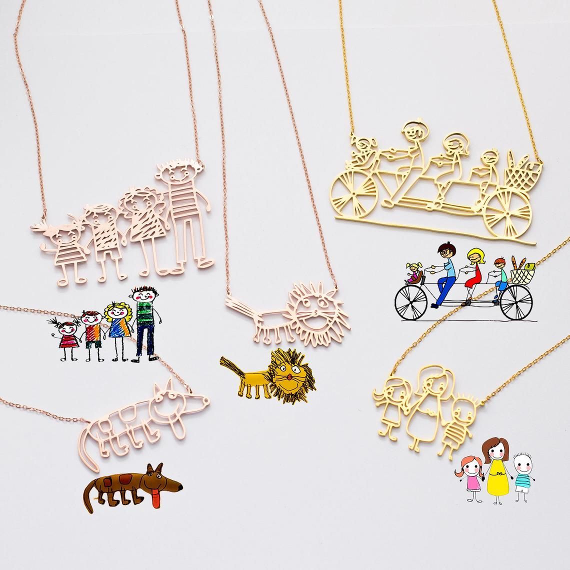 Gold and rose gold necklaces in the shape of drawings, including people and animals.