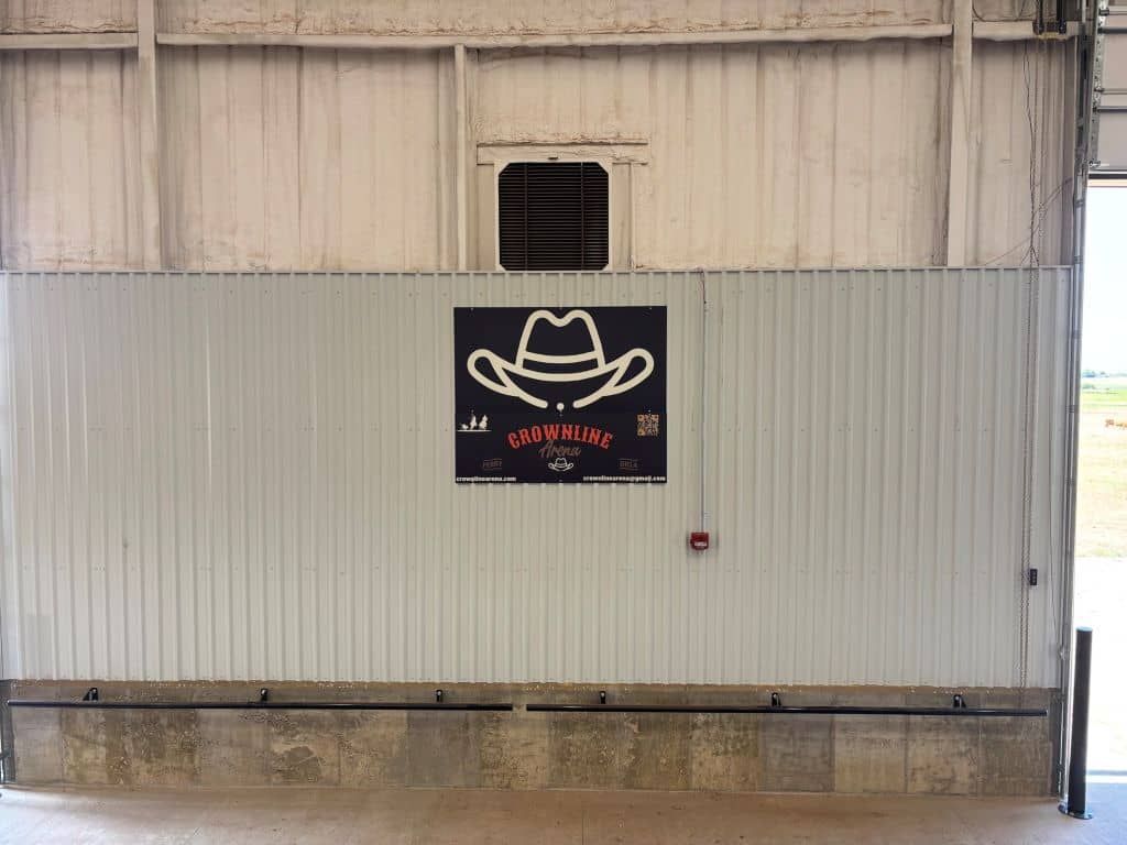 A sign on a wall with a cowboy hat on it