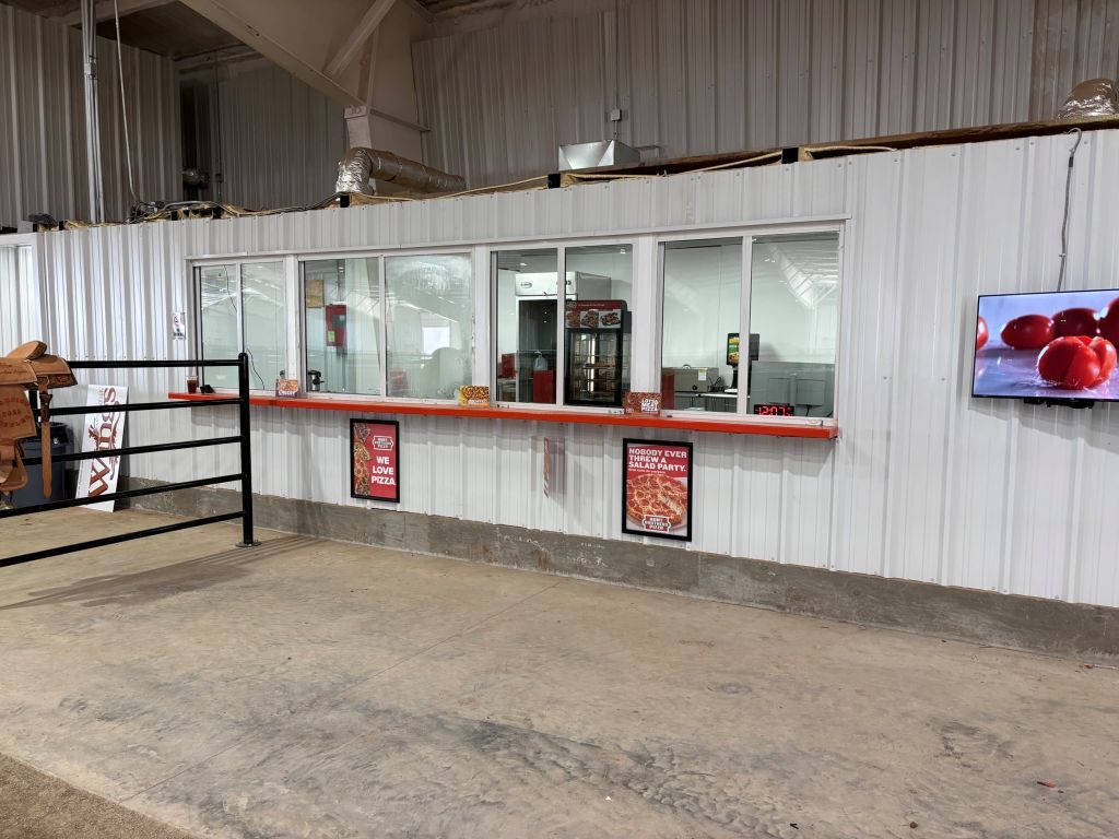 A large room with a lot of windows and a tv on the wall.