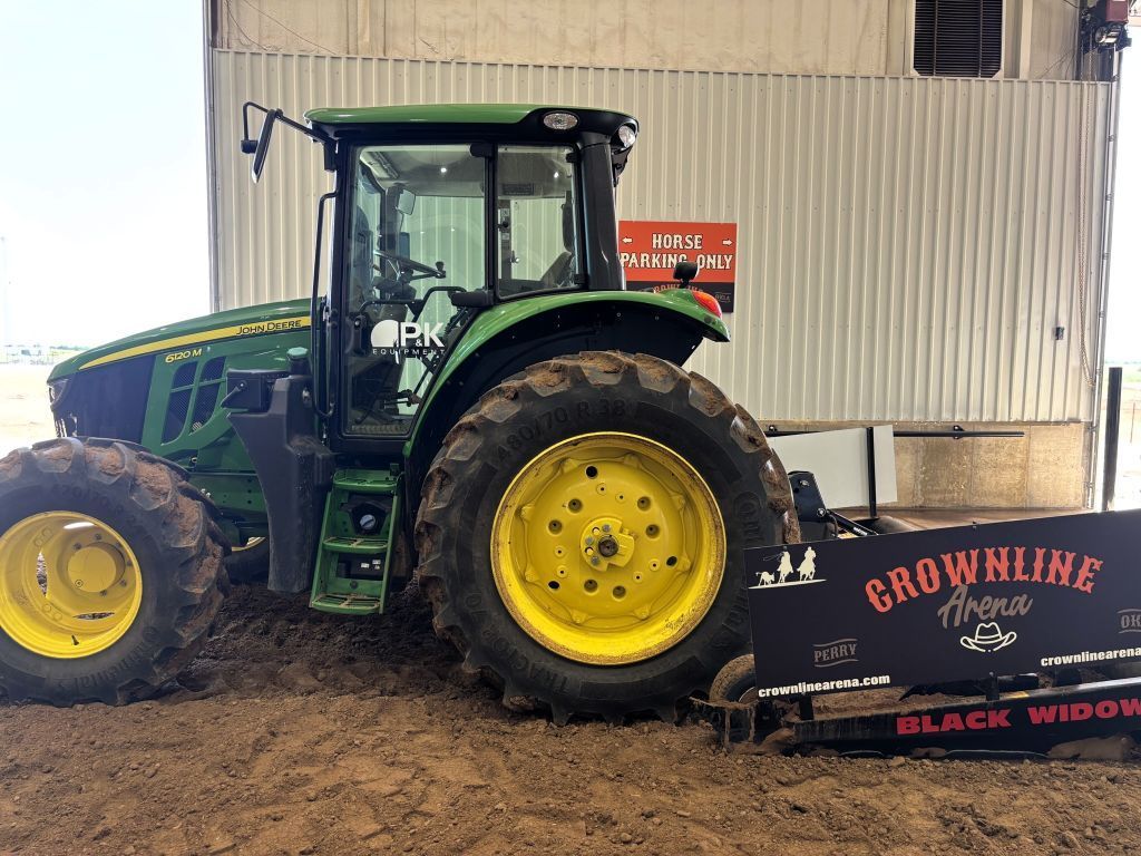 Green and yellow John Deere tractor pulling a 