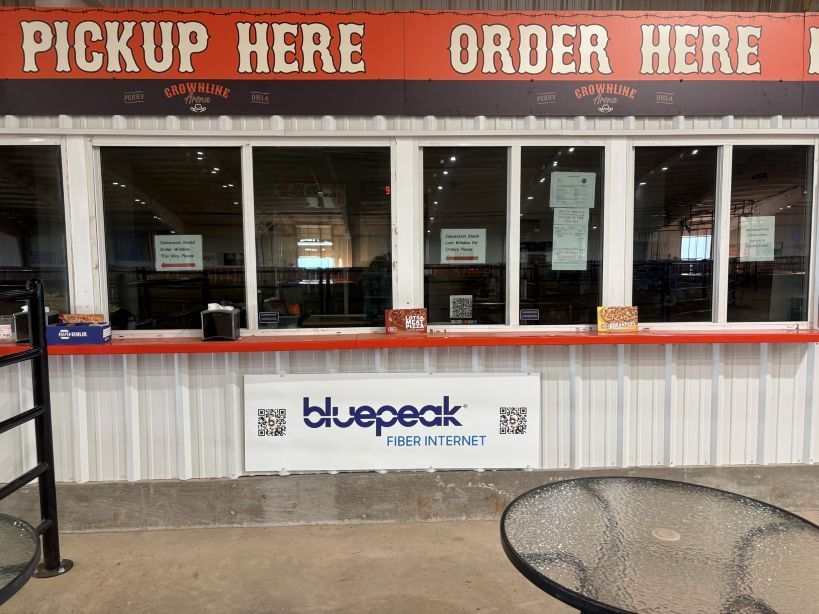Order and pickup windows at a restaurant. Orange sign says 