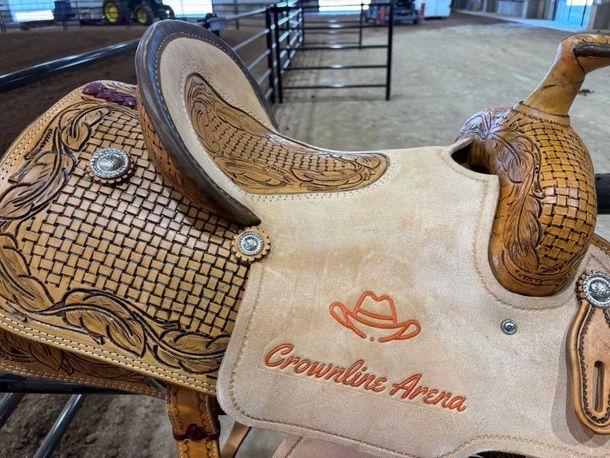 A close up of a saddle that says crownline arena on it
