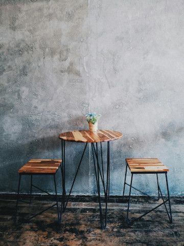 Folding chair at a dining table with a geyser, stretcher, and desk.