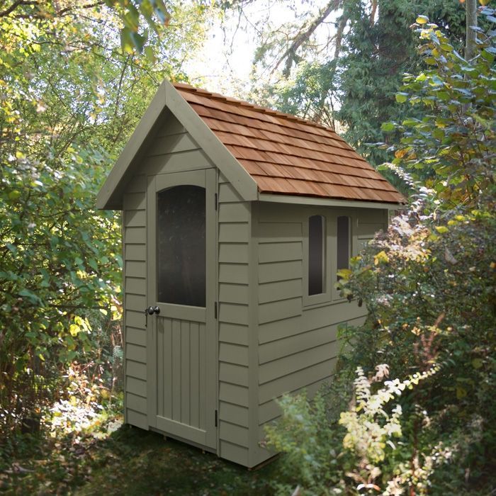 Green painted shed in a lush Sunderland garden in the UK. Expertly painted by Foxglove Decor.