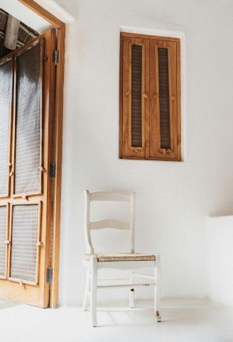 Medicine chest near a wardrobe, folding chair, and upright bannister.