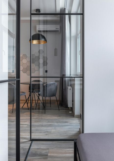 A room with a glass door leading to a dining room.