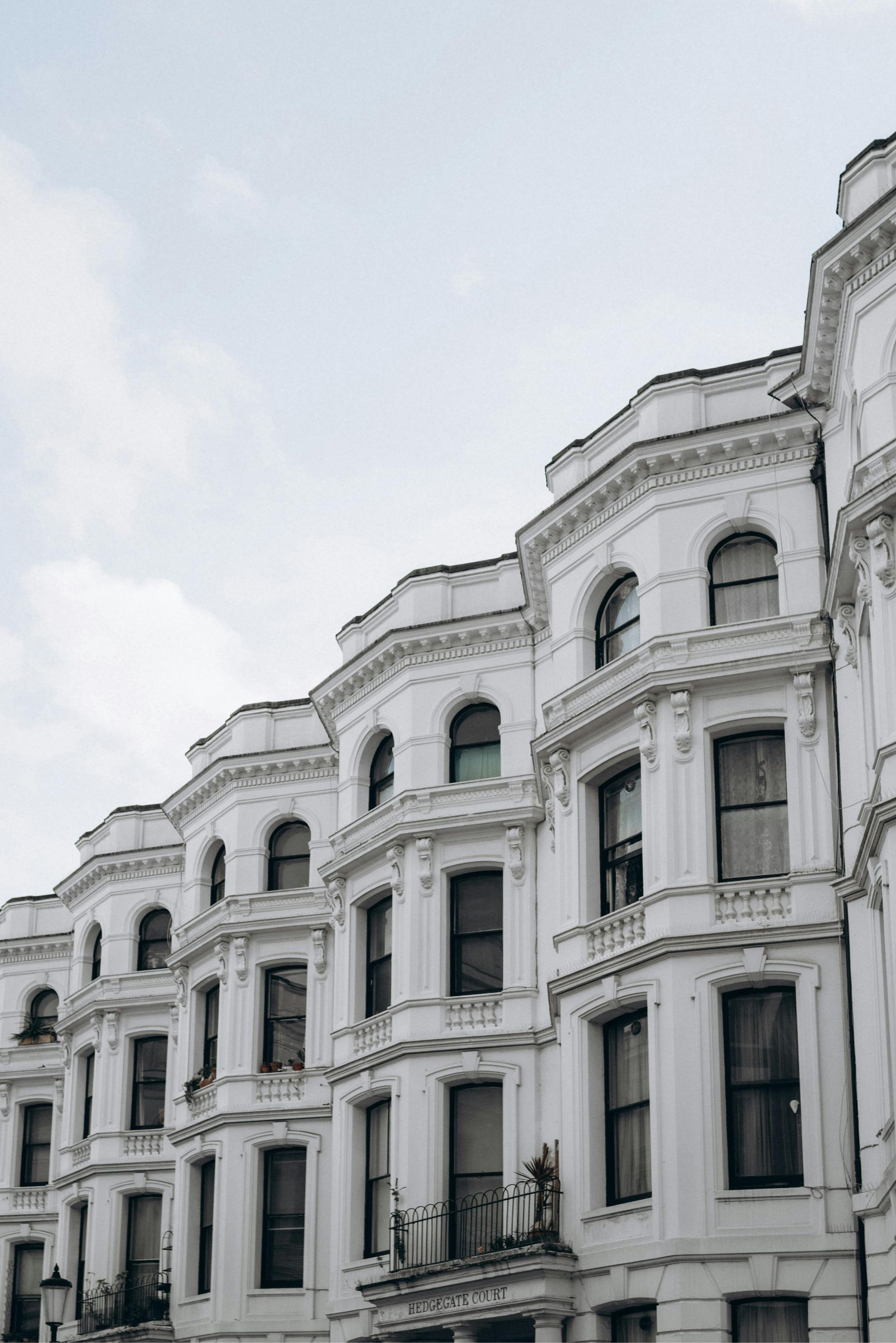 Lovely terraced flats in Sunderland, UK. Expertly painted in white exterior house paint by Foxglove Decor.