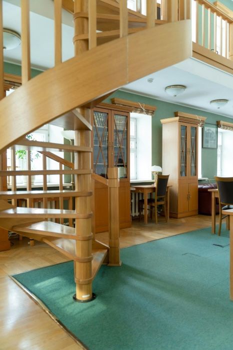 A wooden spiral staircase leading up to a second floor. Expertly varnished by Foxglove Decor in Sunderland.