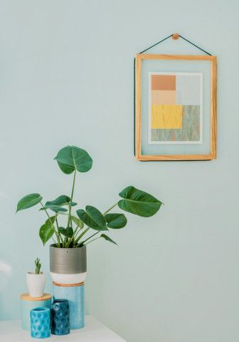 Pot and vase near a medicine chest, altar, and dining table.