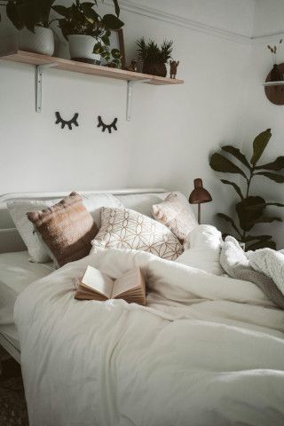 Quilt-covered four-poster bed near a studio couch, sliding door, and mosquito net.