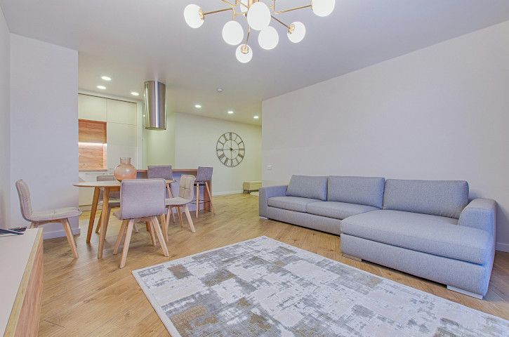 Studio couch with a home theater, patio, sliding door, and window shade in a living area.