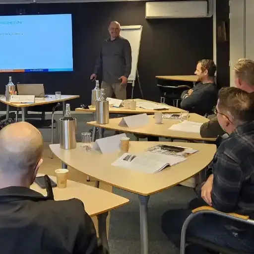 Jean-Pierre  geeft training aan een groep mensen