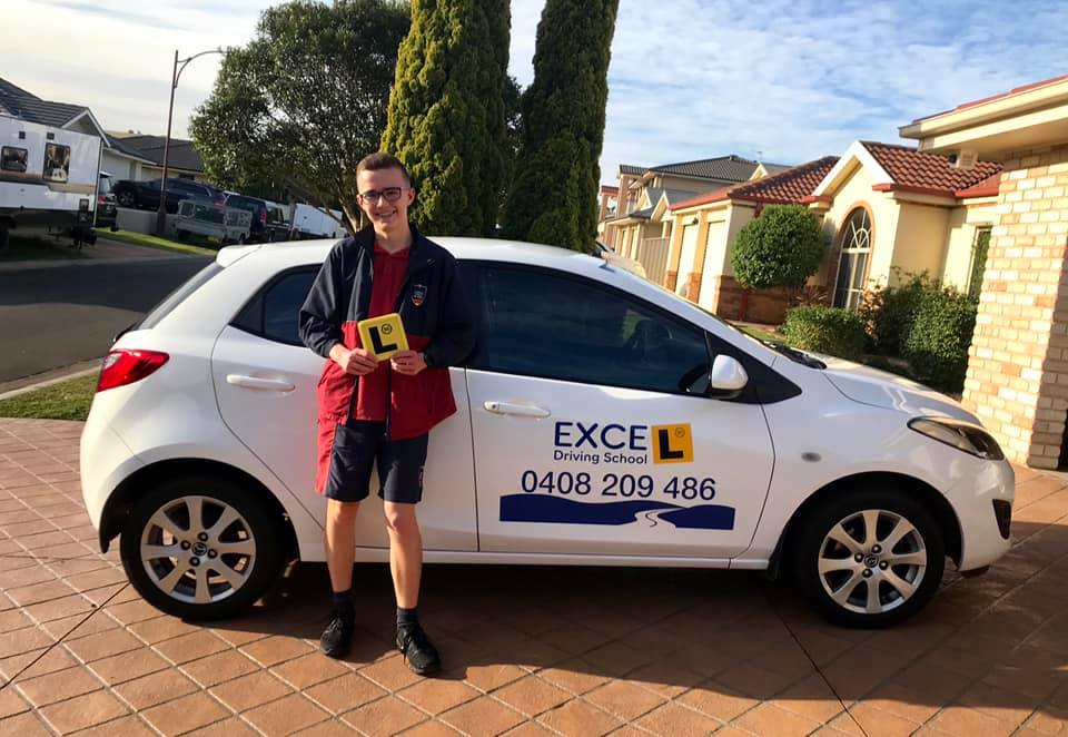 Student Driver Holding a Yellow L Plate — Wollongong, NSW — Excel Driving School