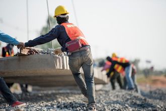 worker pushing a concrete block
