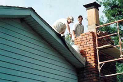 Two Men Working On Chimney — St. Charles, MI — Nader's Masonry, Inc. Two Men Working On Chimney — St. Charles, MI — Nader's Masonry, Inc.