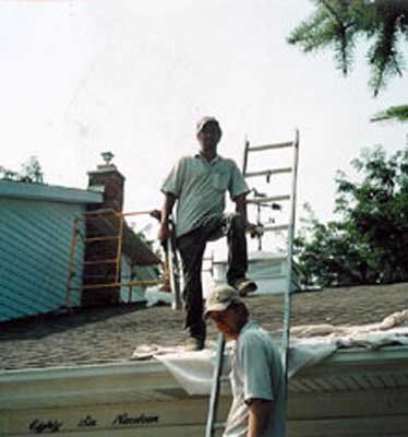 Two Men Climbing On Roof — St. Charles, MI — Nader's Masonry, Inc.