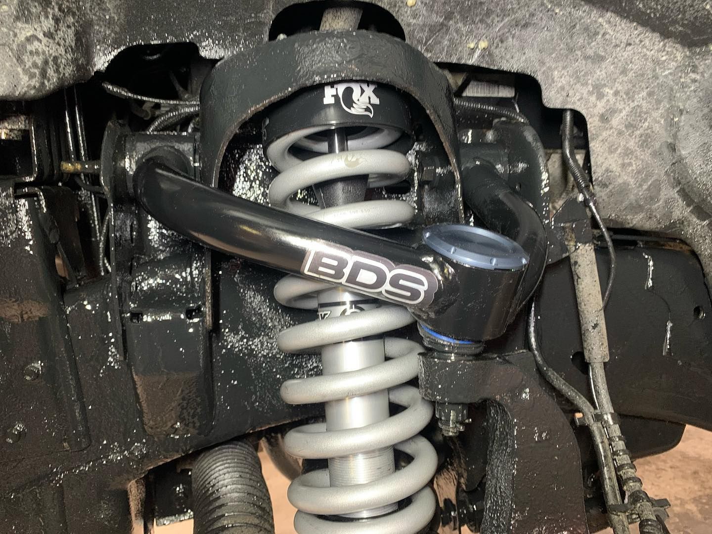 Black suspension component with gray spring and FOX and BDS branding.