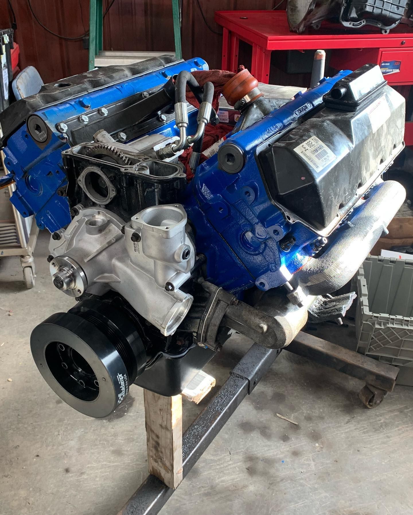 Blue engine block assembly on a stand. Shows the engine with several components attached.