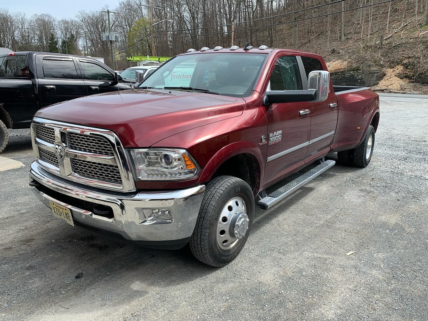 Red Dodge Ram dually pickup truck parked outdoors on a paved lot. Red Dodge Ram dually pickup truck parked outdoors on a paved lot.