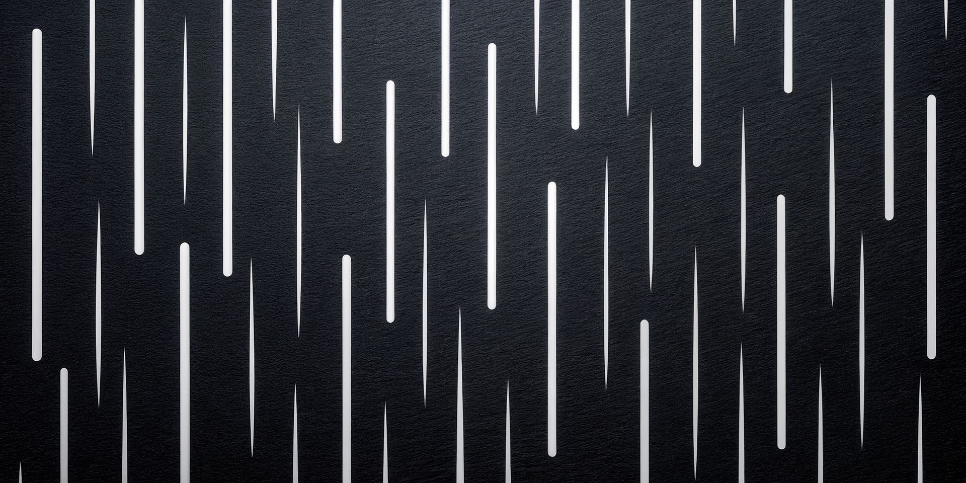 Black surface with vertical white lines of varying lengths.