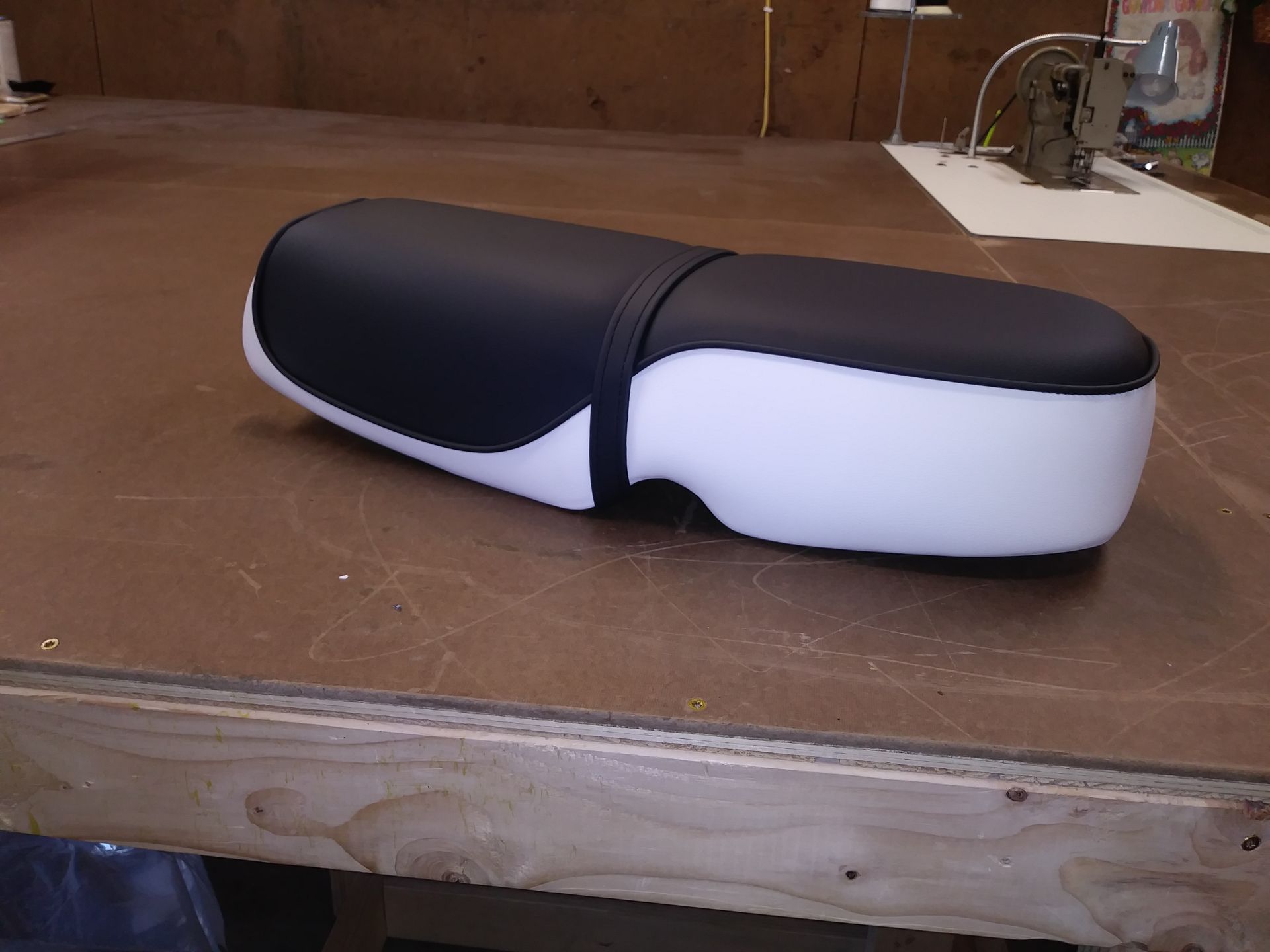 Black and white case on a wooden table with a small workbench background