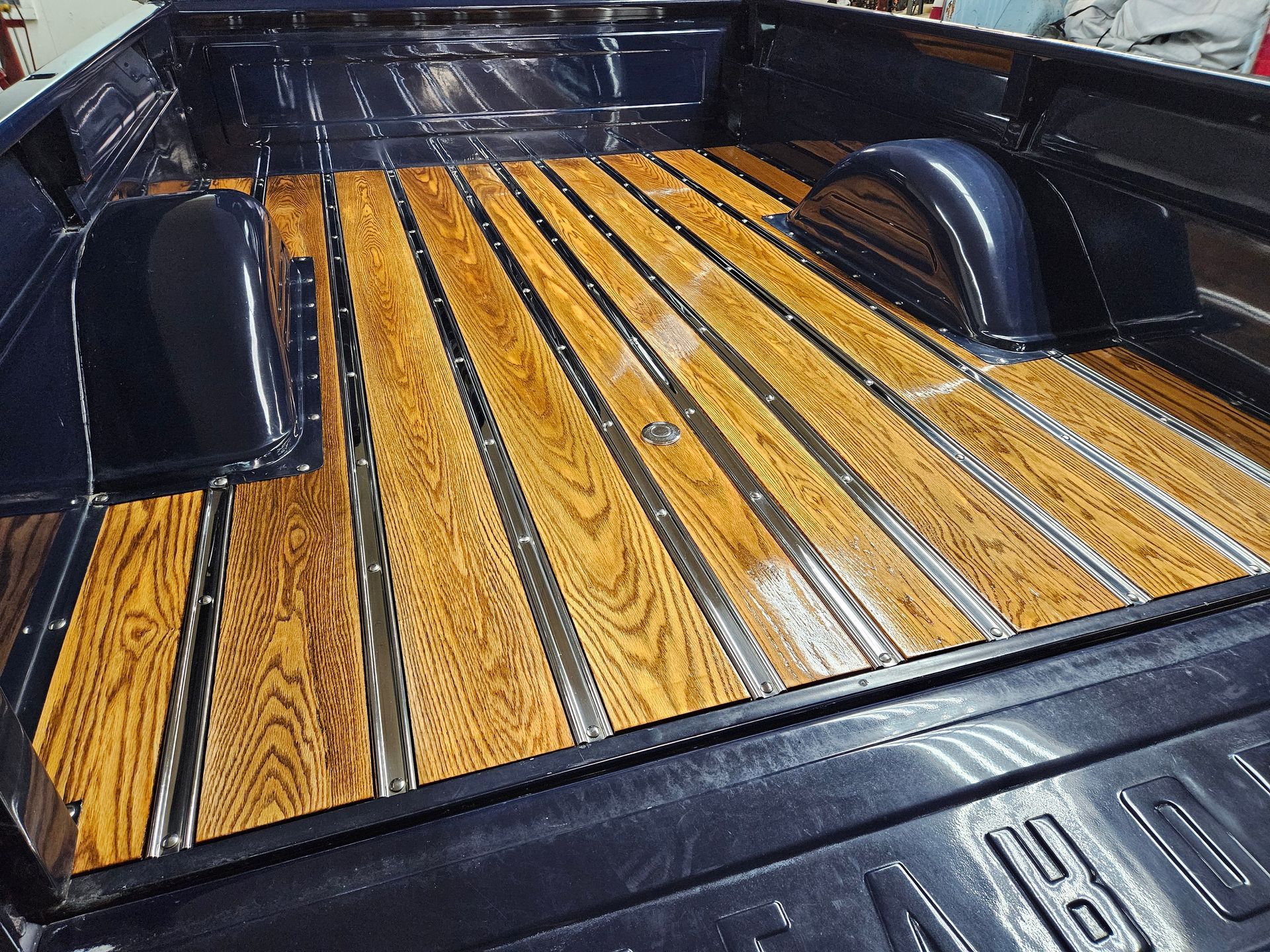 Classic truck bed with glossy wood planks and dark metal trim