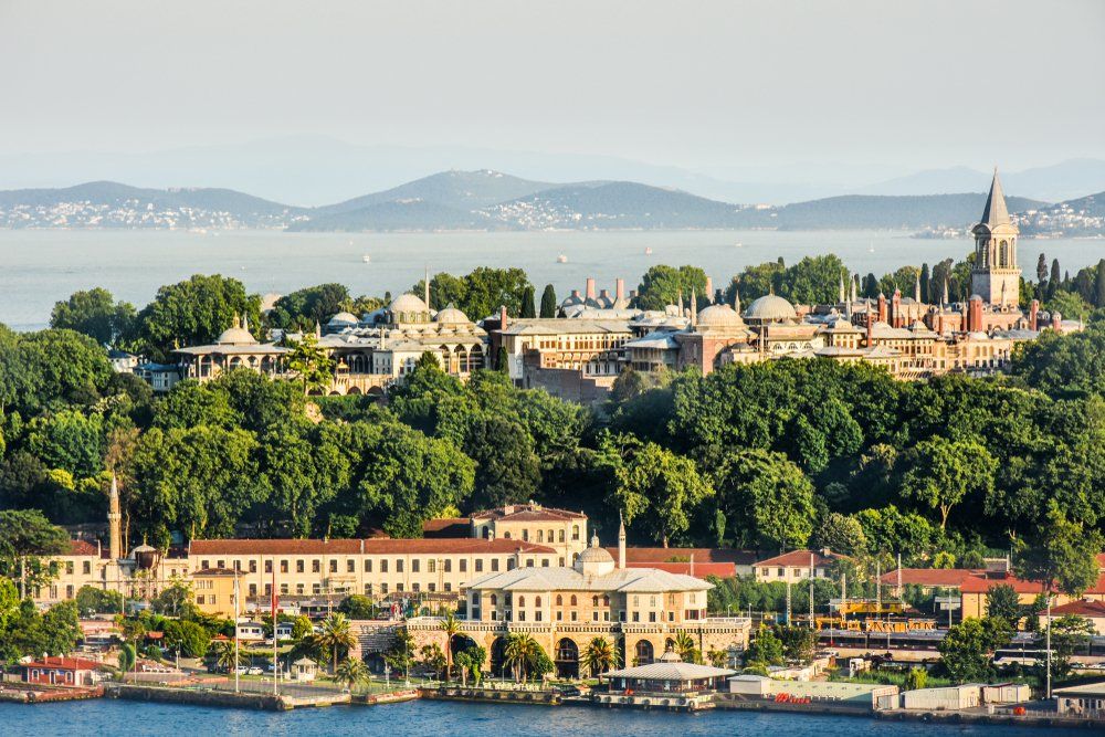 An aerial view of a city surrounded by water and trees.