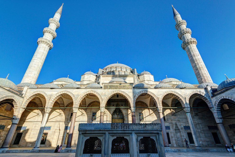 A large mosque with a blue sky in the background.