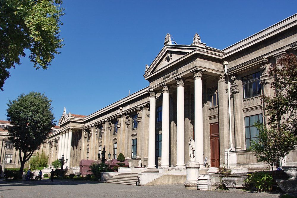 A large building with columns and a blue sky in the background