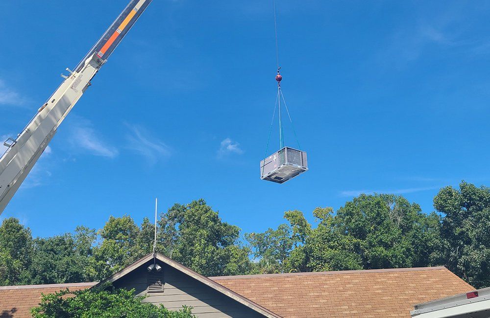 Lifting The Air Conditioner — Orlando, FL — Rick’s Crane Service