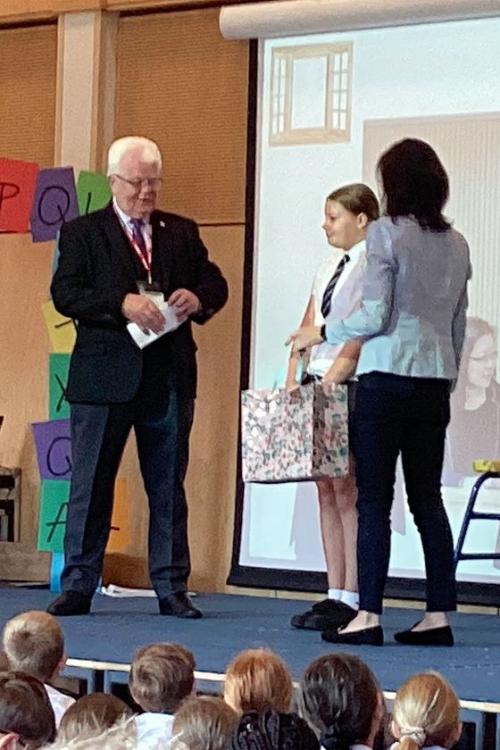 Court Artist winner being presented with her prize by the Deputy Lieutenant of Greater Manchester, and a magistrate from the MIC team.
