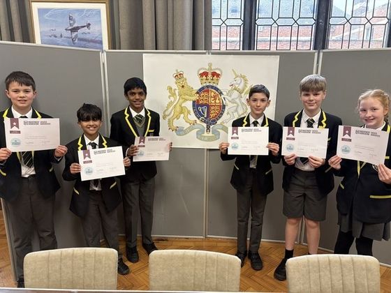 Students proudly displaying the certificates presented to all participants. © 2026 Stockport Grammar School