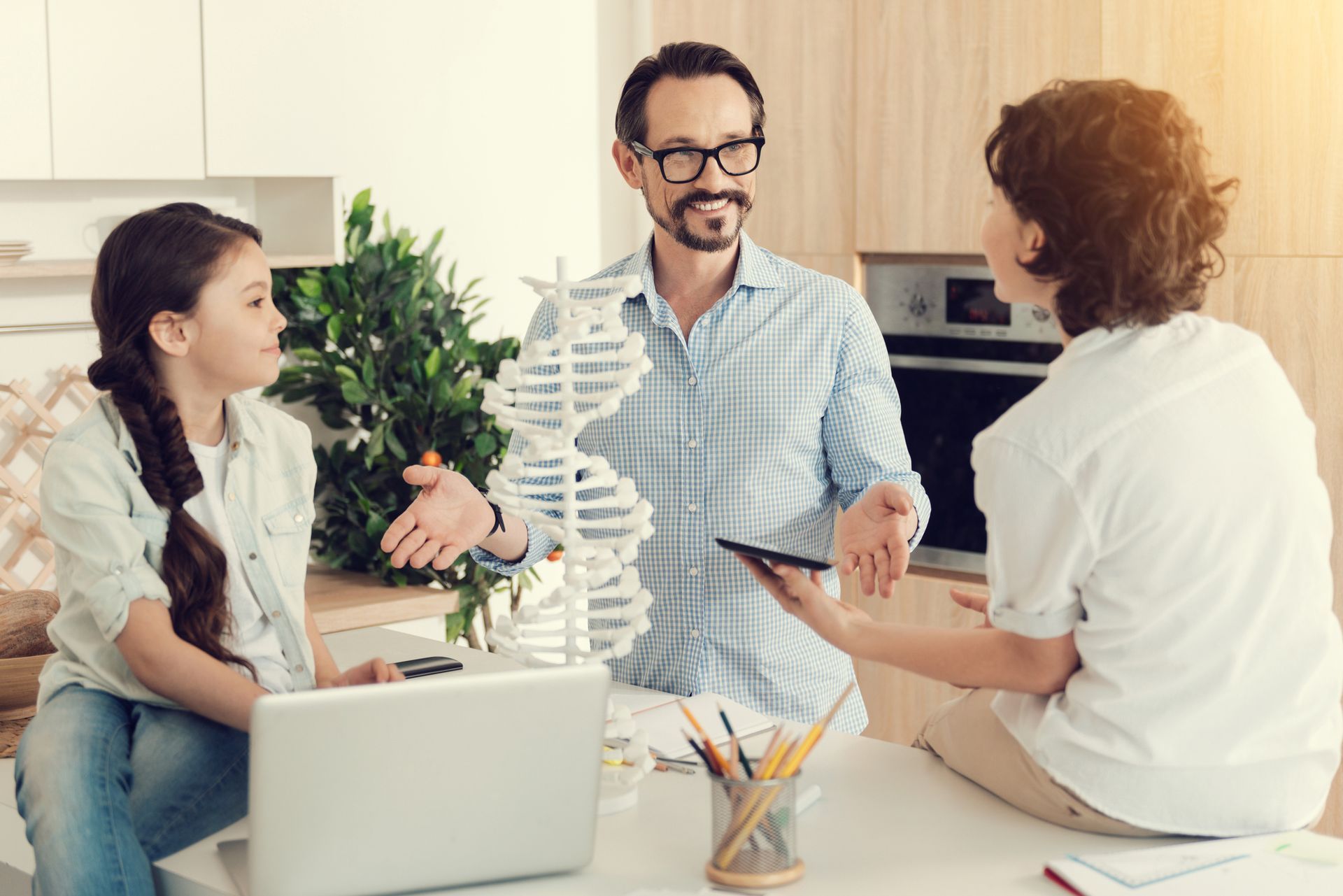 Man reviewing documents with woman looking on; home setting.