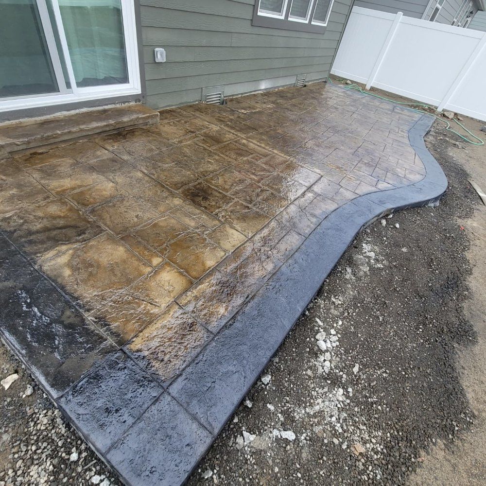 Stamped concrete patio with a dark border.