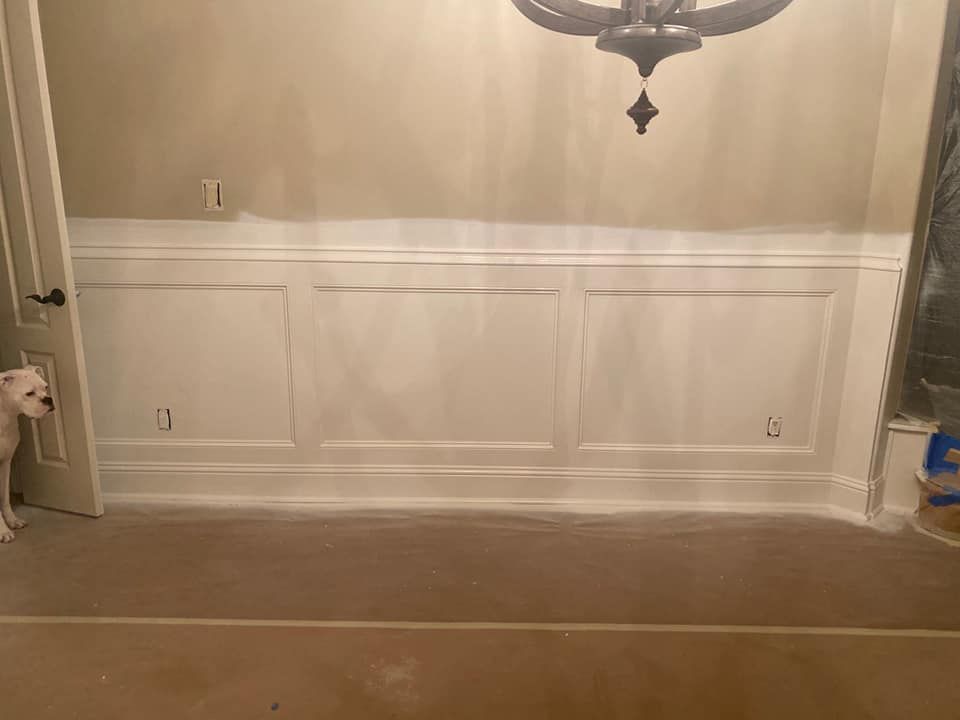 A wall with a chandelier hanging from it.