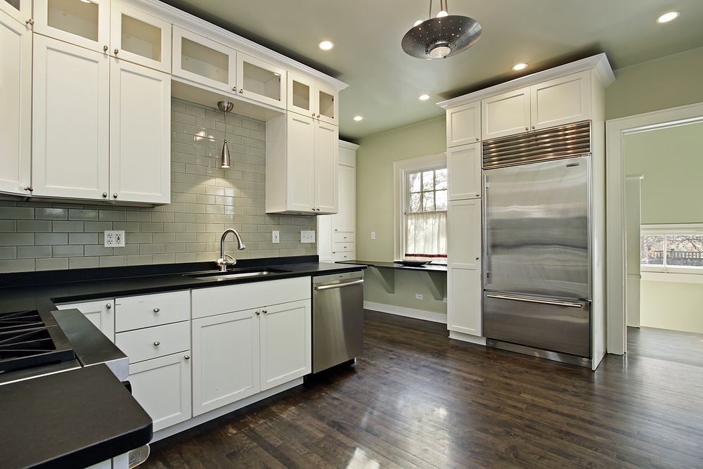 A kitchen with white cabinets and stainless steel appliances.