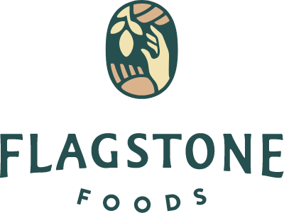 Flagstone Foods logo: hand holding branch with fruit within an oval, green and tan. Company name in green below.