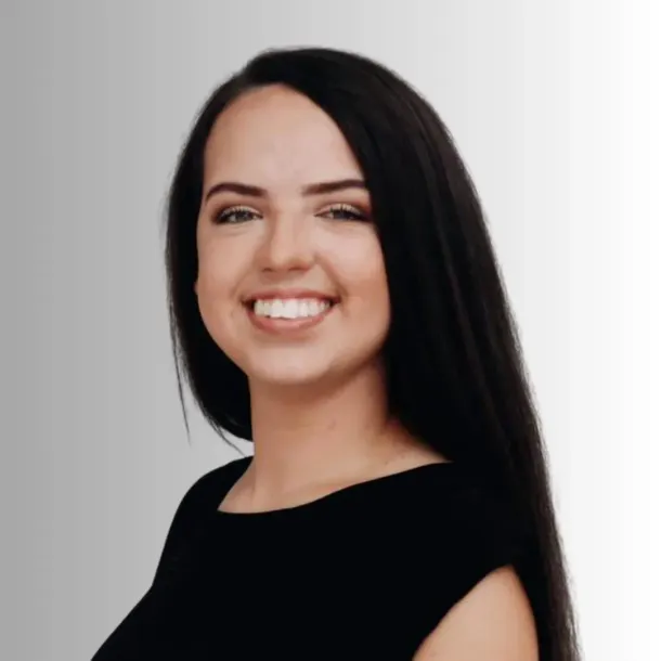 Woman with long dark hair smiles, wearing a black top.
