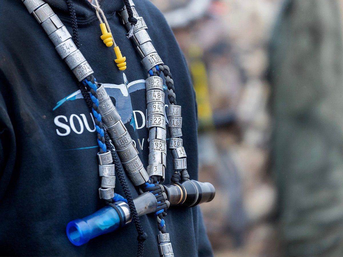 A person wearing a black shirt with the word soul on it