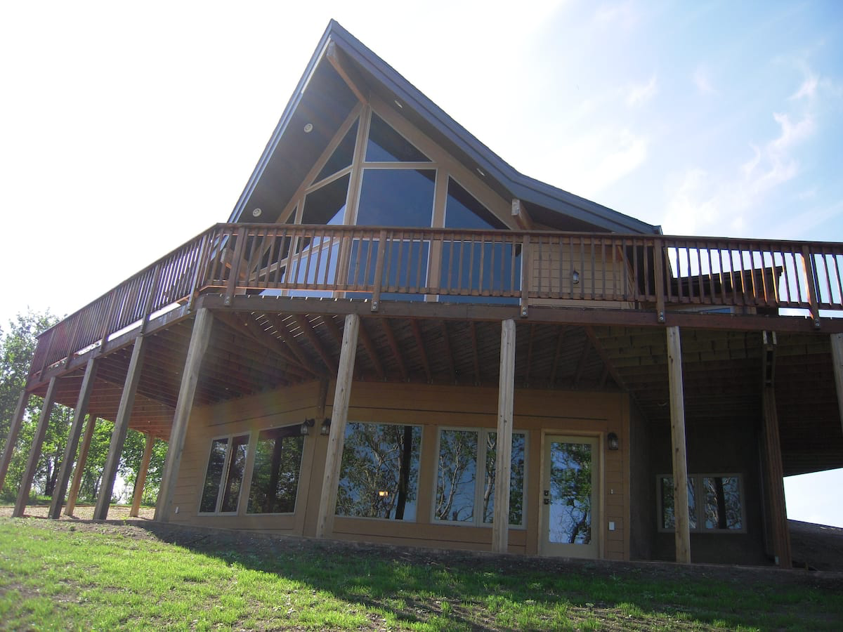 A large house with a large deck on top of it