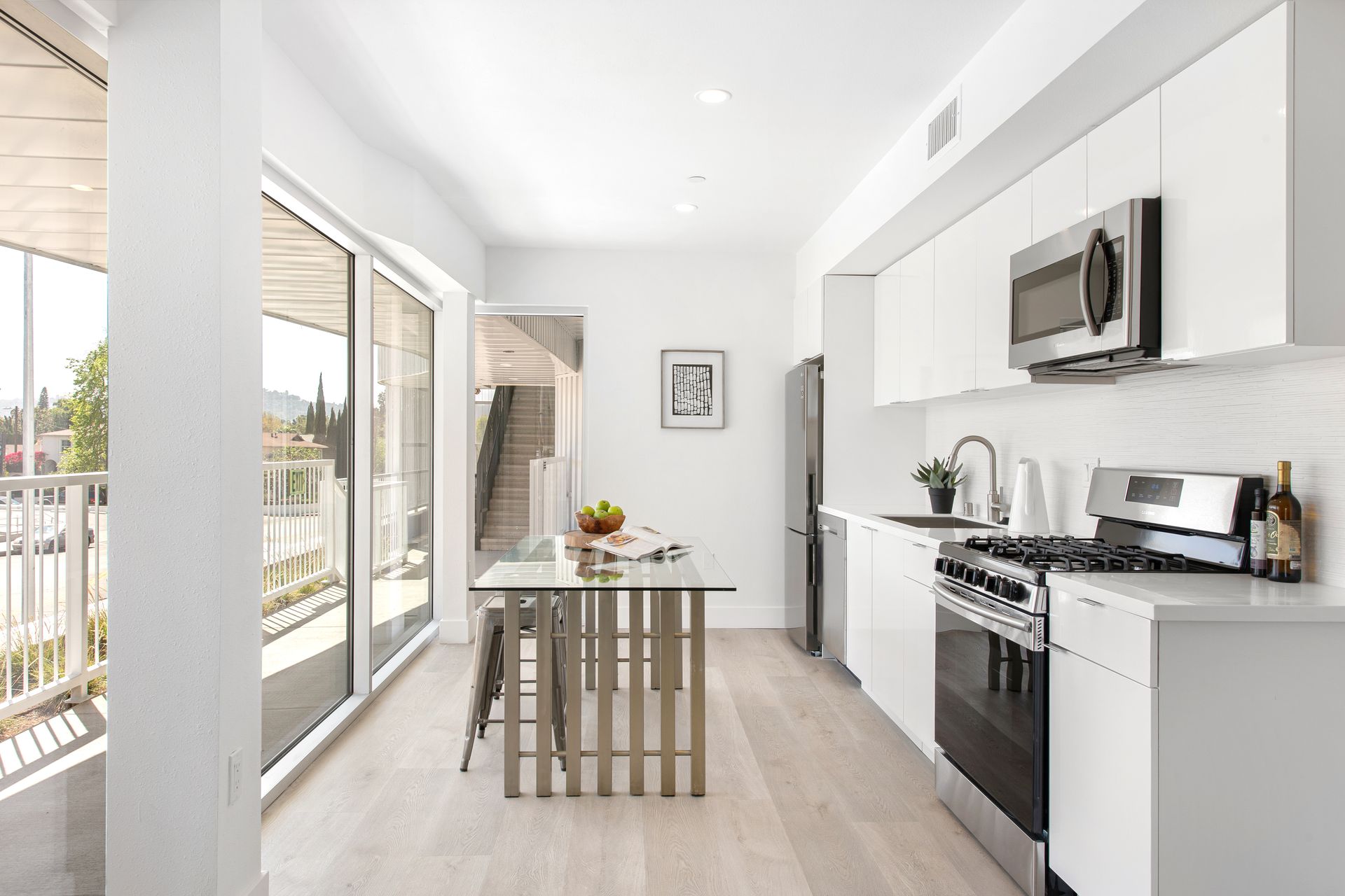 A kitchen with white cabinets and stainless steel appliances