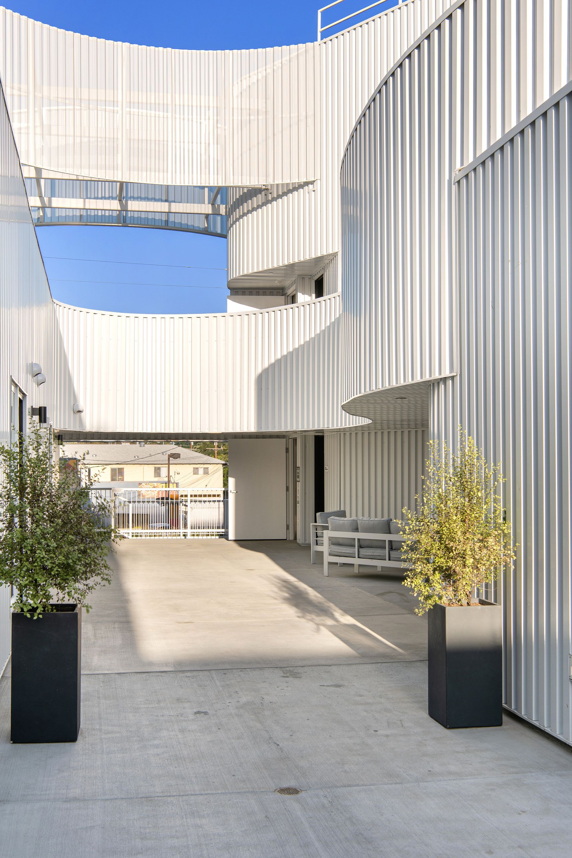 A white building with a staircase leading up to it.